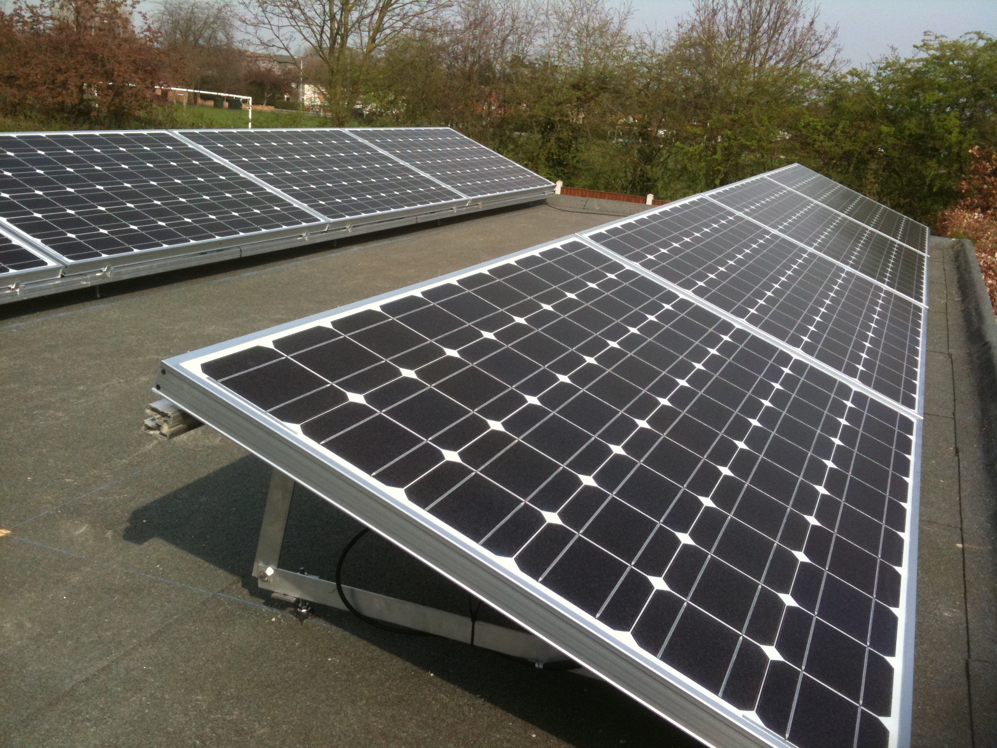 Solar panels fitted onto flat roofs using " Ballast Trays" 